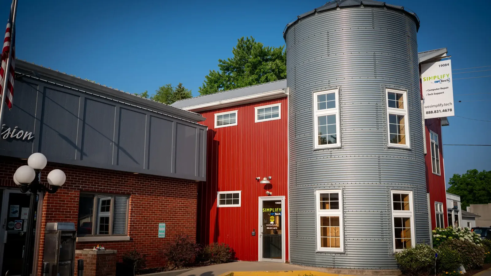 The red storefront and round silo tower on Market Street in New Paris