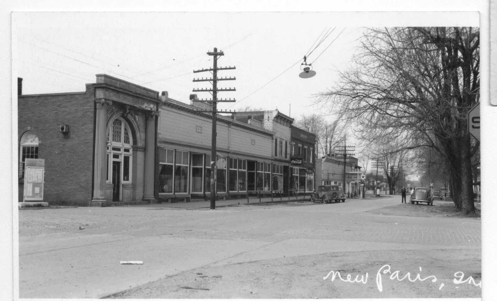 Early New Paris, Indiana street scene with telephone poles and lines