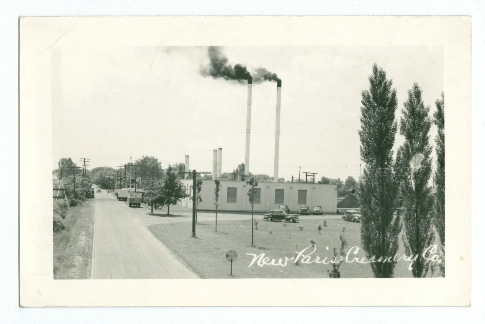 Early 1900s street view of New Paris, Indiana with telephone lines