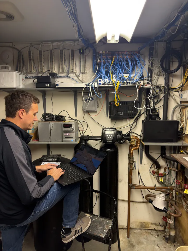 A technician working on network equipment in the New Paris exchange